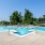 a swimming pool with trees in the background