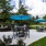 a patio with a table and chairs and umbrellas