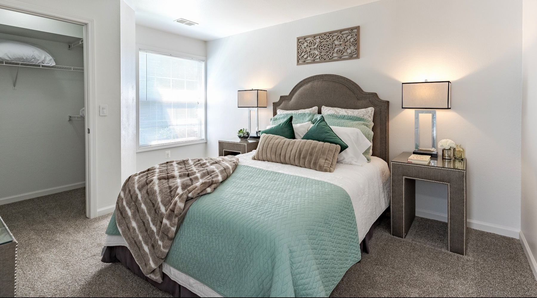 bedroom with lamps and a large window