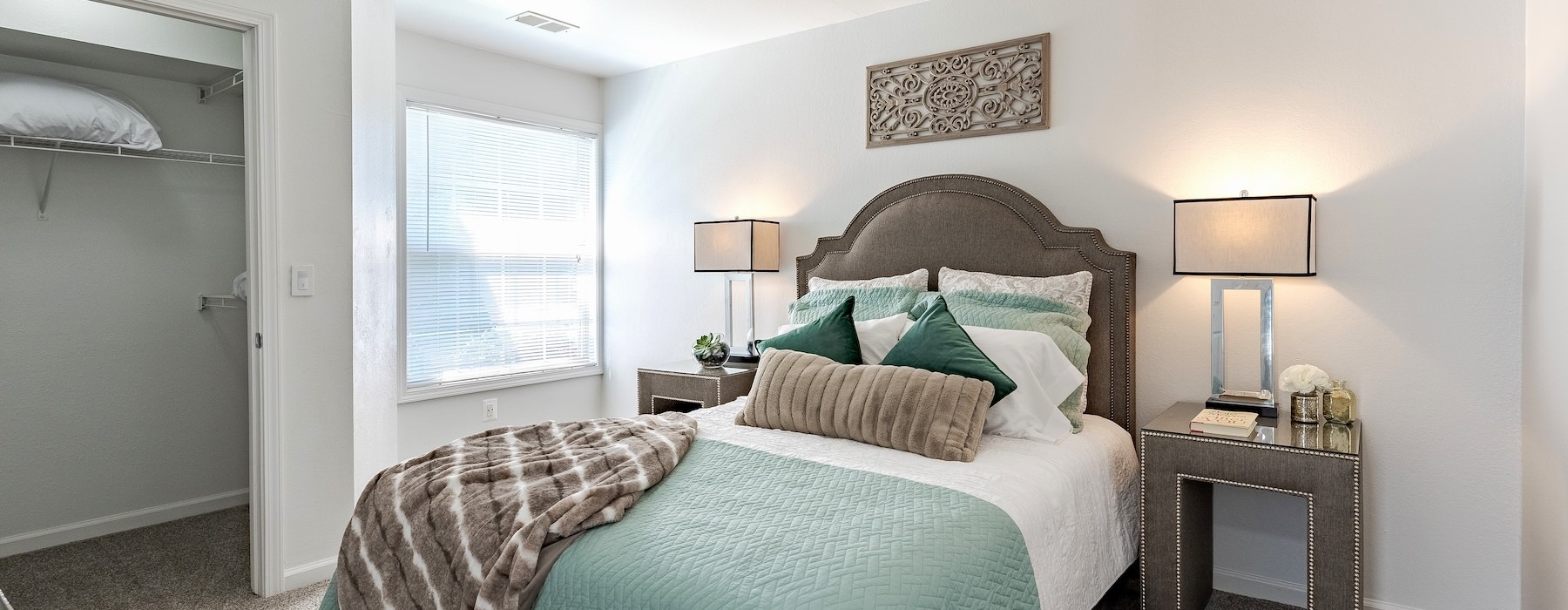 bedroom with lamps and a large window
