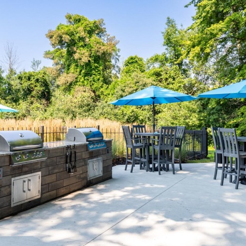 Access to resident-only features grilling area with chairs, tables and umbrellas