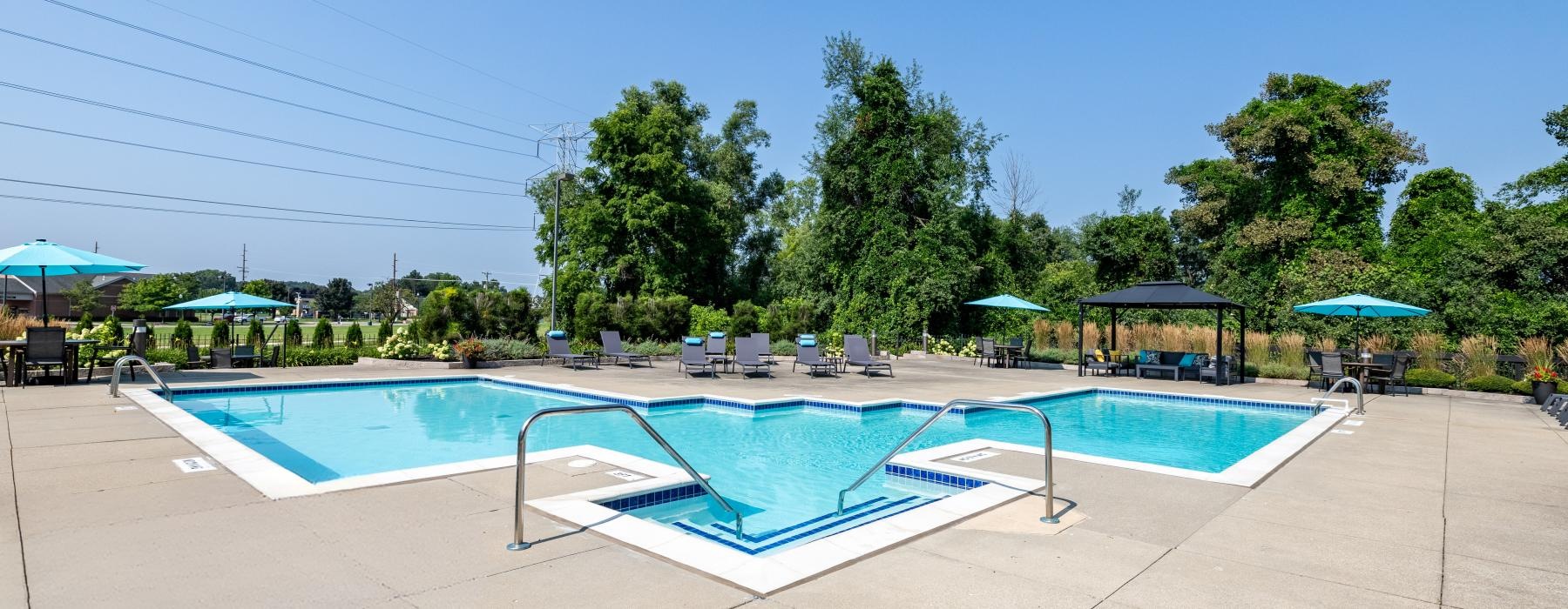 a swimming pool with trees in the background